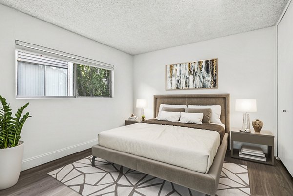 Luxurious bedroom with elegant decor at The Fulton Apartments