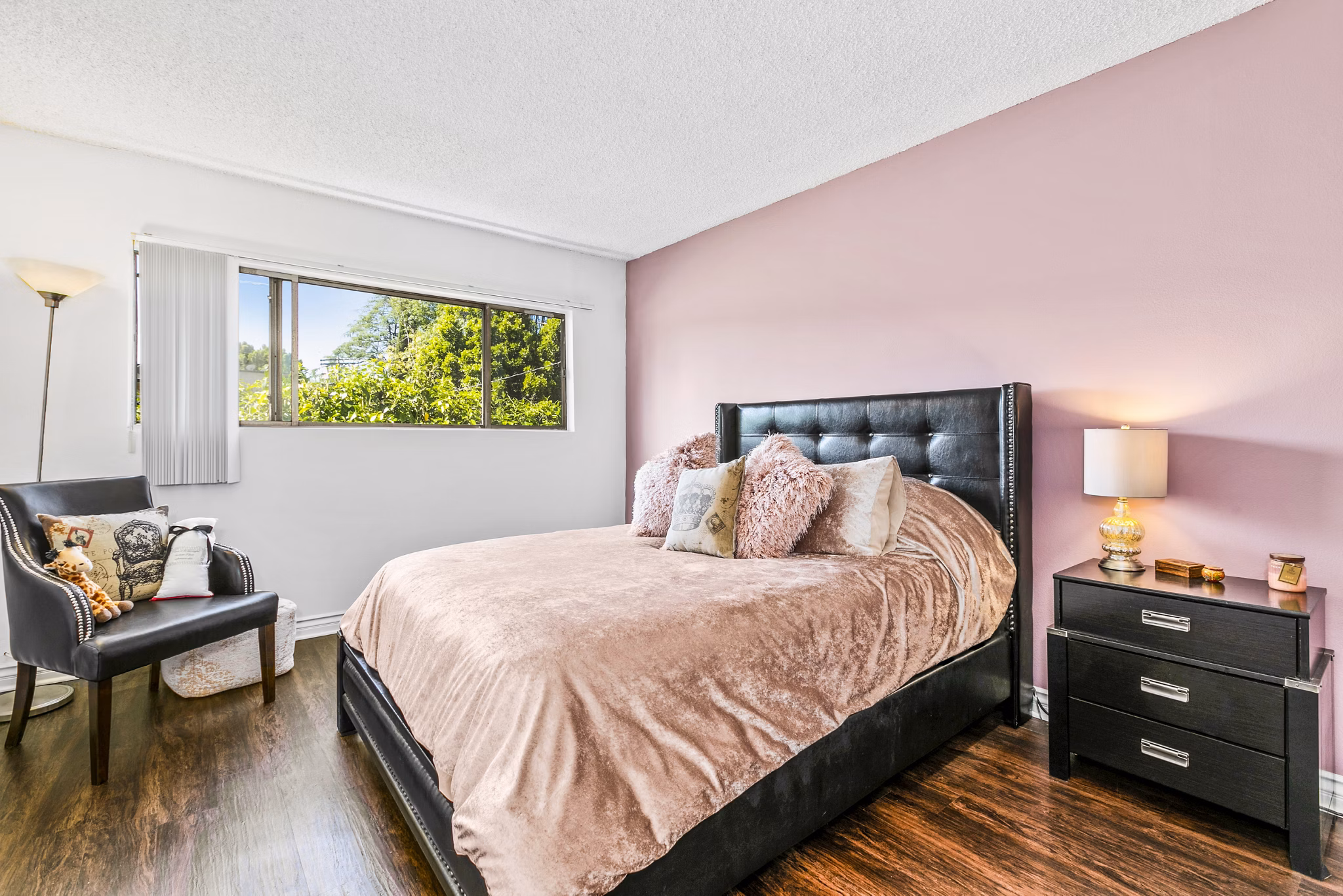Cozy bedroom with elegant decor at The Fulton Apartments, a luxury living option by Greystar