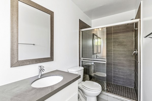 The Fulton Apartments: Modern bathroom with sleek fixtures and marble tiles