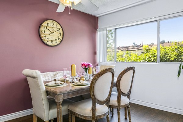 Dining area with elegant seating and modern lighting at The Fulton Apartments