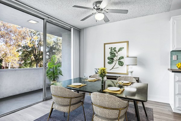 Dining area with modern decor and large windows at The Fulton Apartments in Greystar luxury community