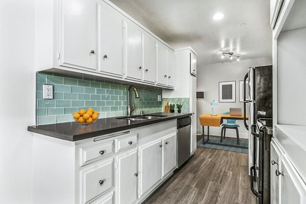 Modern kitchen with stainless steel appliances at The Fulton Apartments