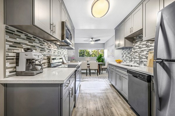 Modern kitchen with stainless steel appliances at The Fulton Apartments in luxury Greystar community