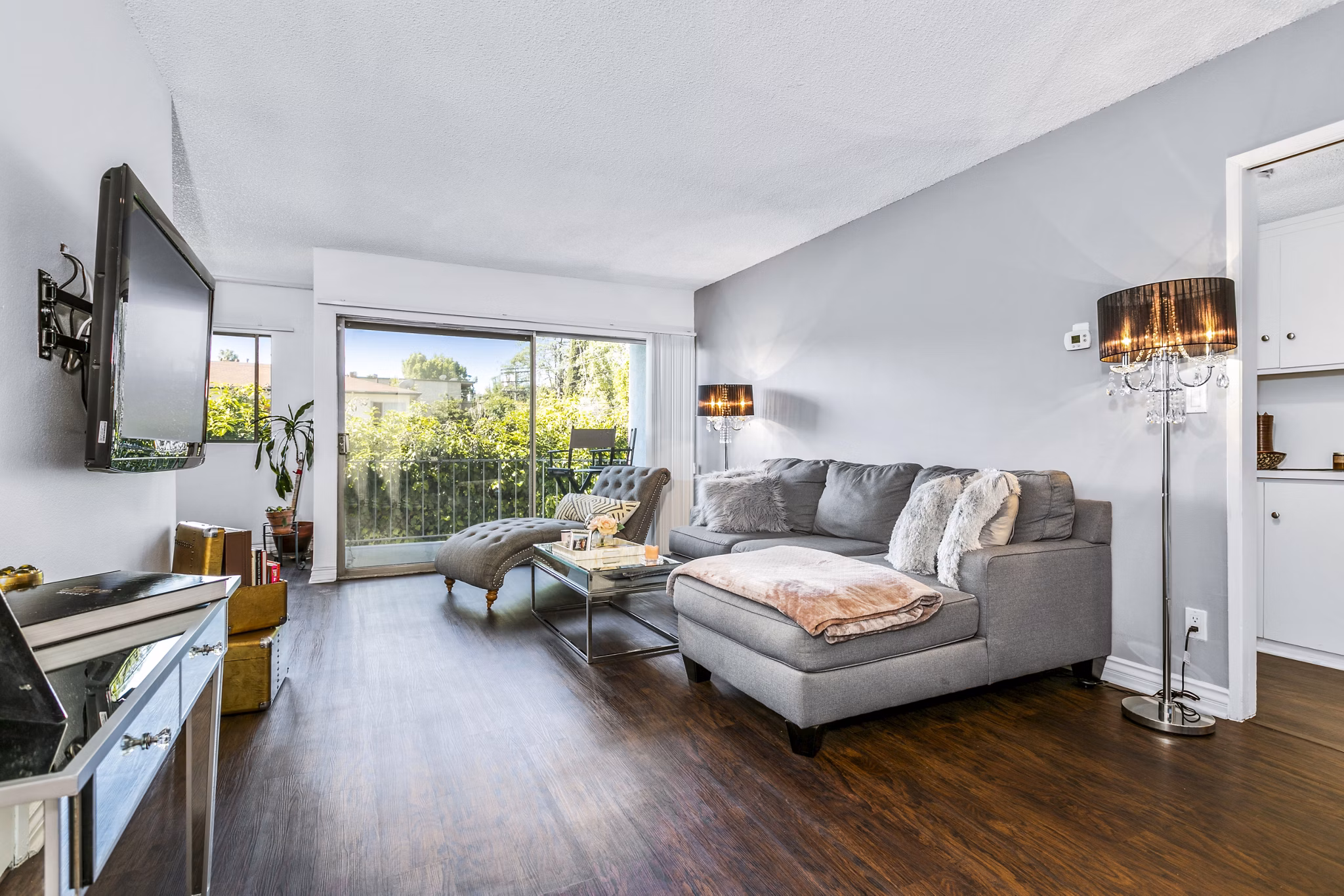 Spacious living room with stylish decor and large windows at The Fulton Apartments, a luxury Greystar apartment community
