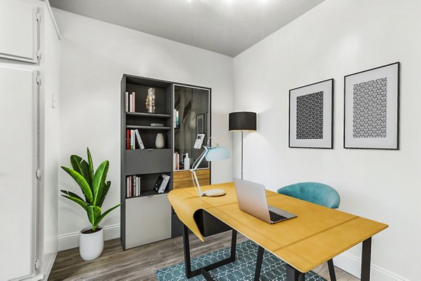 The Fulton Apartments: Modern home office with natural light and sleek furniture