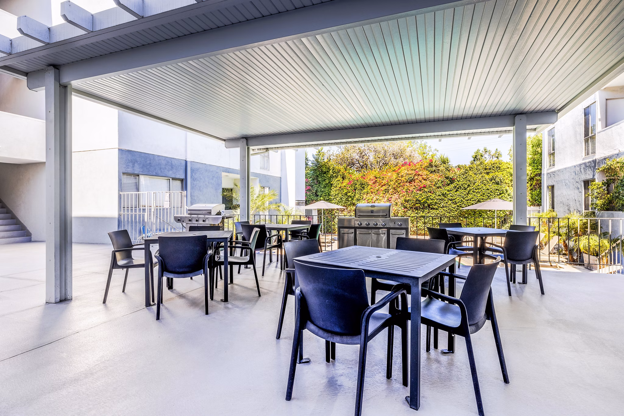Stylish grill area and inviting patio at The Fulton Apartments, perfect for outdoor gatherings and relaxation in a luxury setting