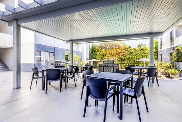 Stylish grill area and inviting patio at The Fulton Apartments, perfect for outdoor gatherings and relaxation in a luxury setting