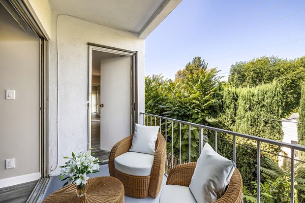 Modern patio/balcony with stylish furnishings at The Fulton Apartments, offering urban outdoor living experiences for residents