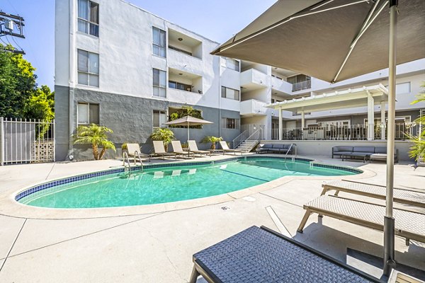 Sparkling outdoor pool with lounge chairs at The Fulton Apartments, a Greystar community, offering luxury living amenities