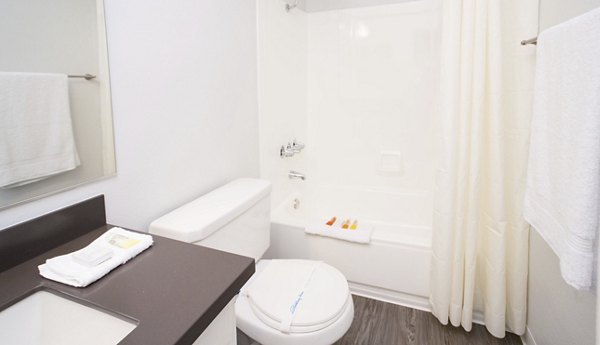 Modern bathroom with sleek fixtures and elegant tiling at Milano Apartments, offering luxury Greystar living in an urban setting