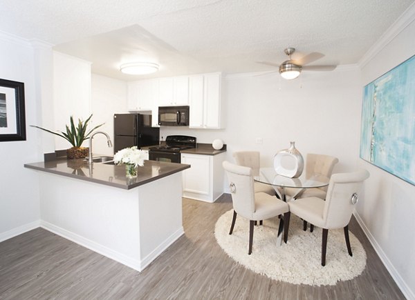 Elegant dining area with contemporary furnishings at Milano Apartments, offering luxury living in a Greystar community