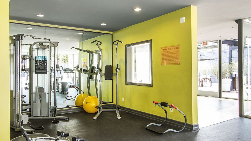 State-of-the-art fitness center equipped with modern machines at Milano Apartments, luxury living by Greystar