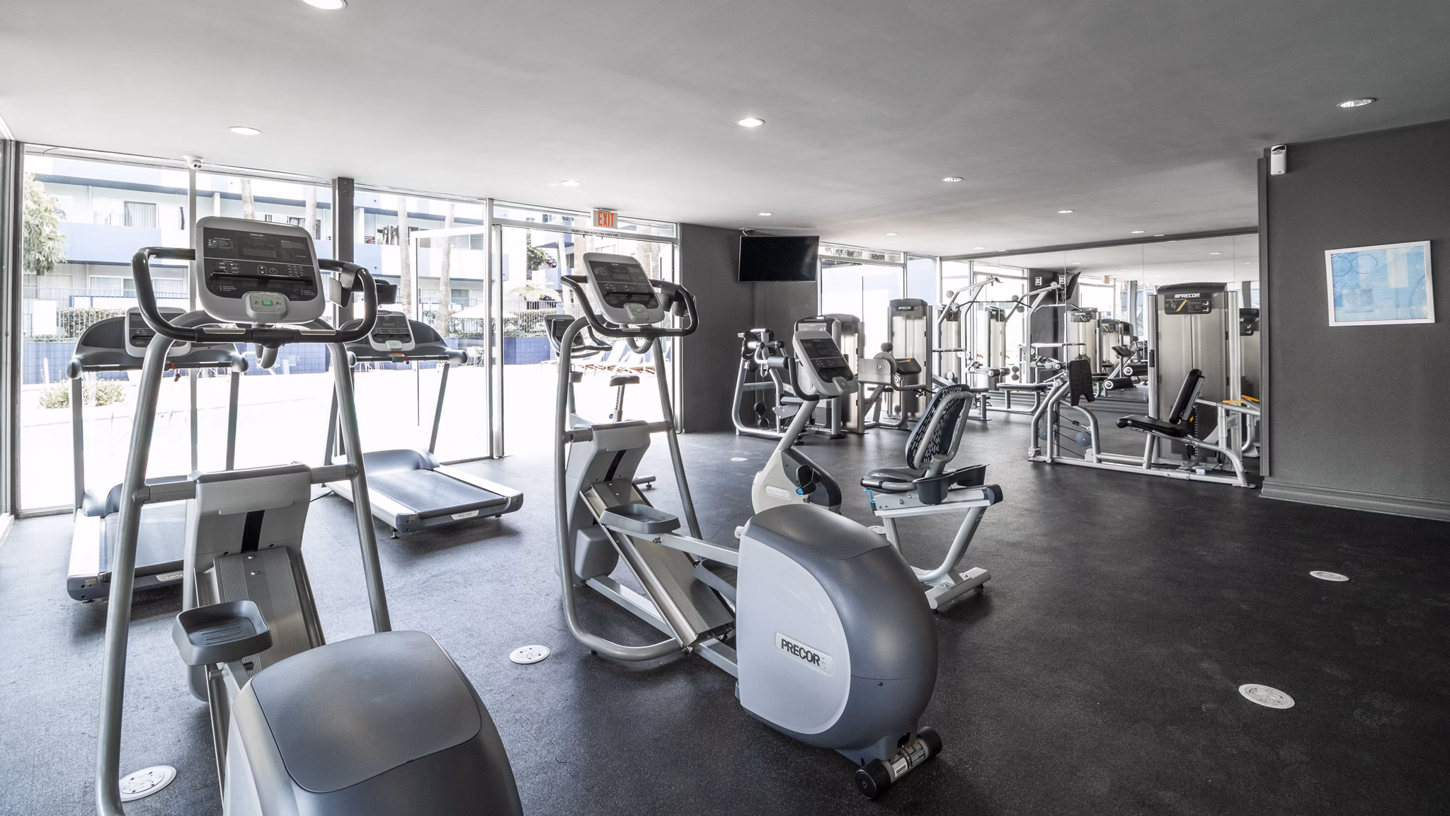 Modern fitness center with state-of-the-art equipment at Milano Apartments, perfect for active lifestyles and workout enthusiasts