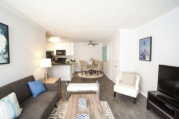 Living room featuring modern decor and natural light at Milano Apartments, a luxury property