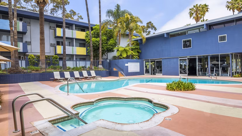 Pool with stylish deck and lounge chairs at Milano Apartments, a Greystar luxury property in a vibrant neighborhood