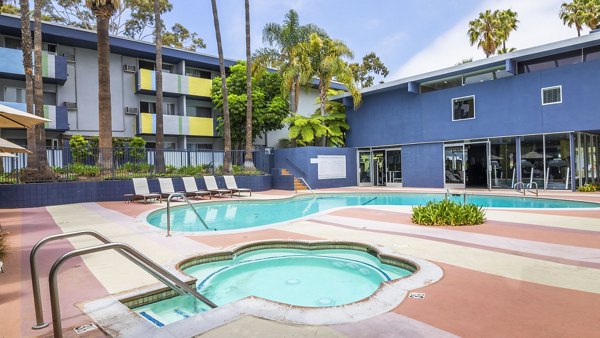Pool with stylish deck and lounge chairs at Milano Apartments, a Greystar luxury property in a vibrant neighborhood