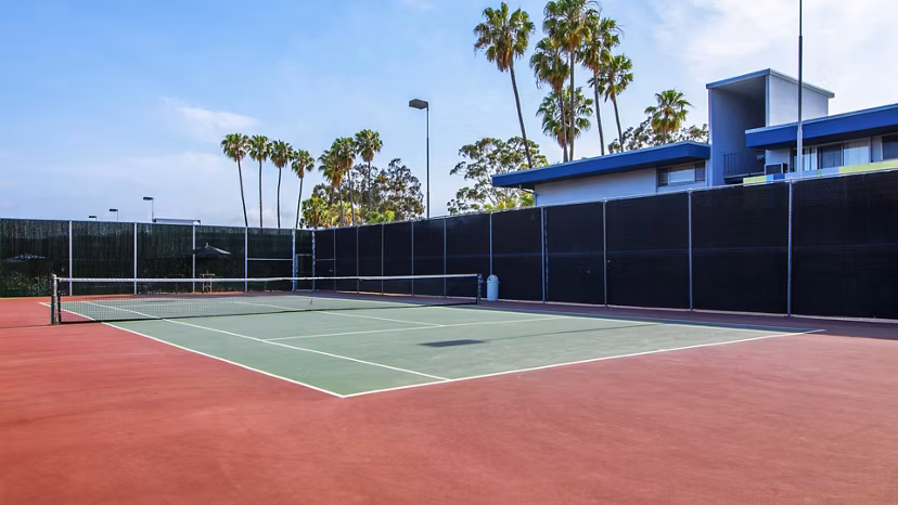 Outdoor sport court with basketball hoops at Milano Apartments, perfect for fitness and recreation