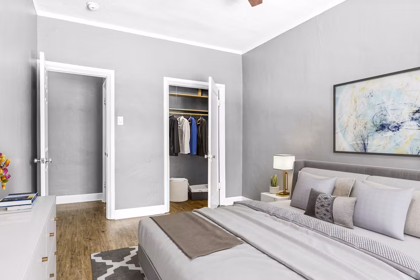 Cozy bedroom with modern design at North Kingsley Apartments featuring luxury furnishings and ample natural light for a serene retreat