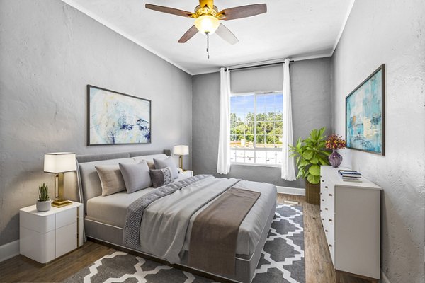 Cozy bedroom featuring plush bedding and natural light at North Kingsley Apartments