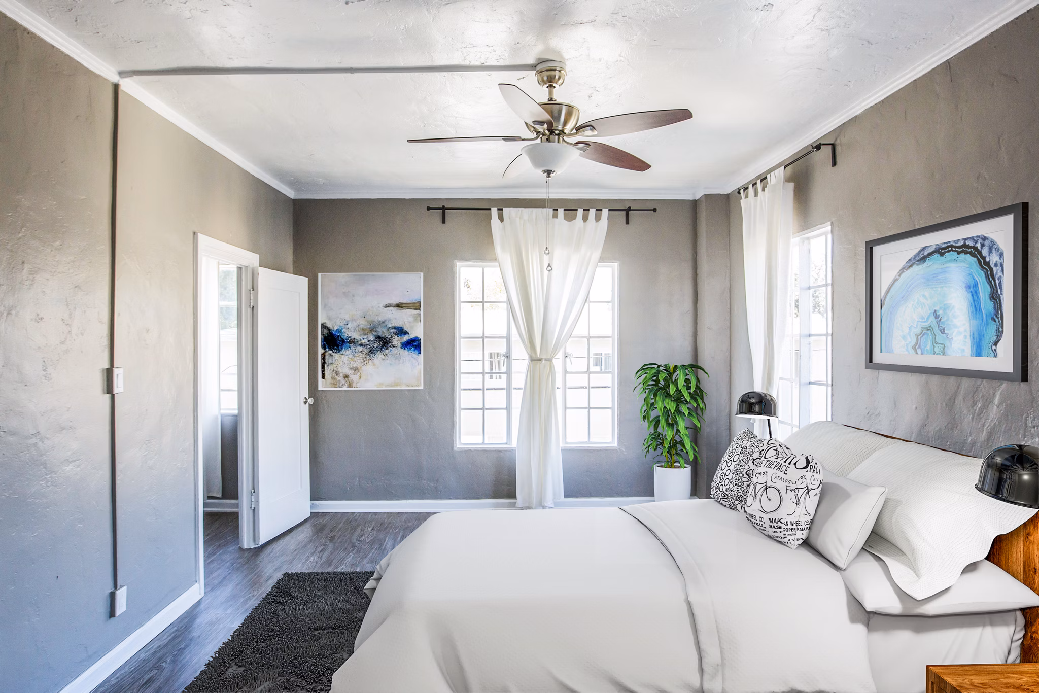Cozy bedroom with modern furnishings at North Kingsley Apartments, a Greystar luxury property