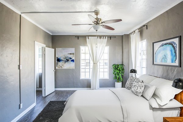 Cozy bedroom with modern furnishings at North Kingsley Apartments, a Greystar luxury property
