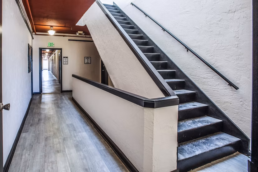 Elegant stairway with polished wood railings at North Kingsley Apartments, highlighting luxury living spaces