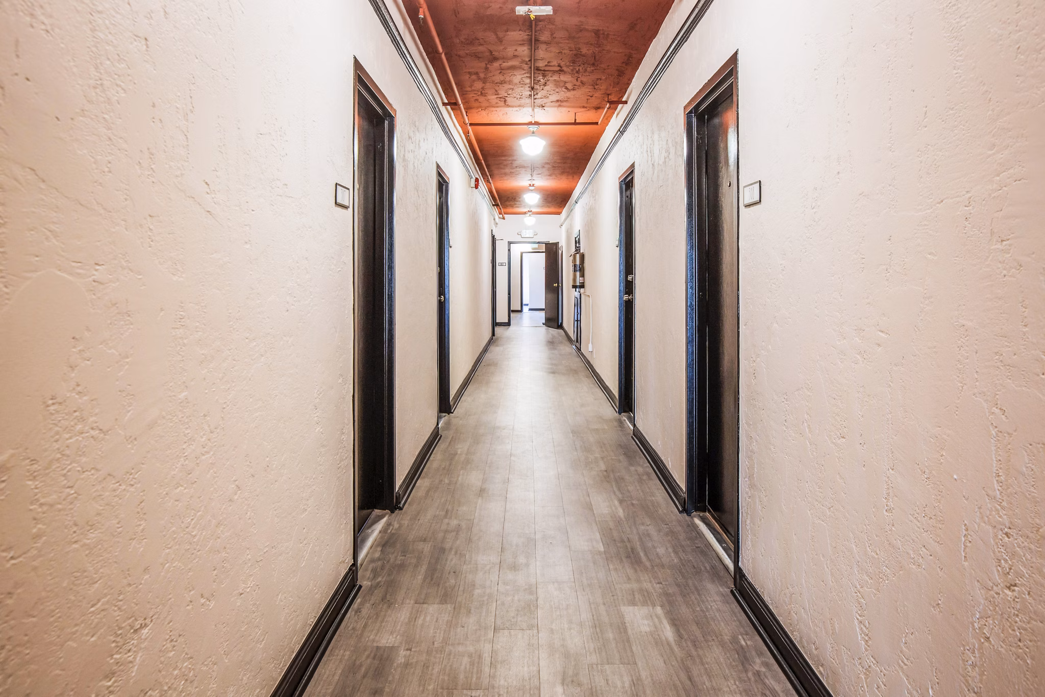 North Kingsley Apartments: Elegant hallway with modern lighting and hardwood floors
