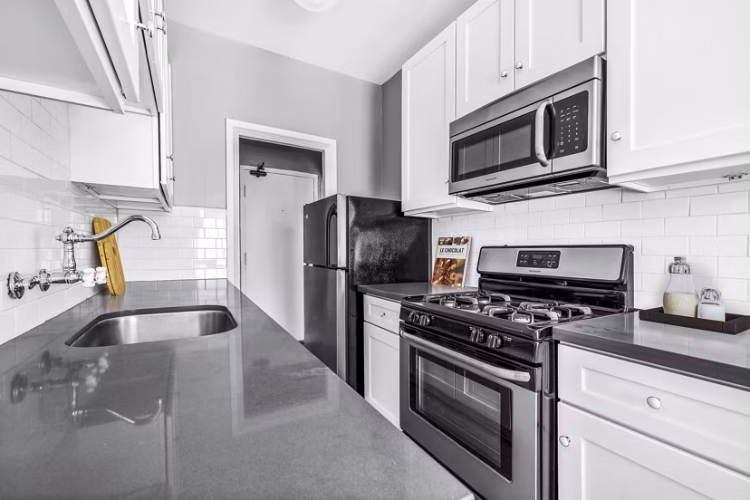 Kitchen featuring modern appliances and granite countertops at North Kingsley Apartments