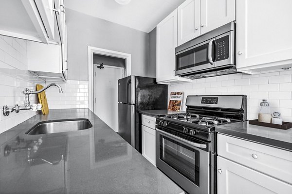 Kitchen featuring modern appliances and granite countertops at North Kingsley Apartments