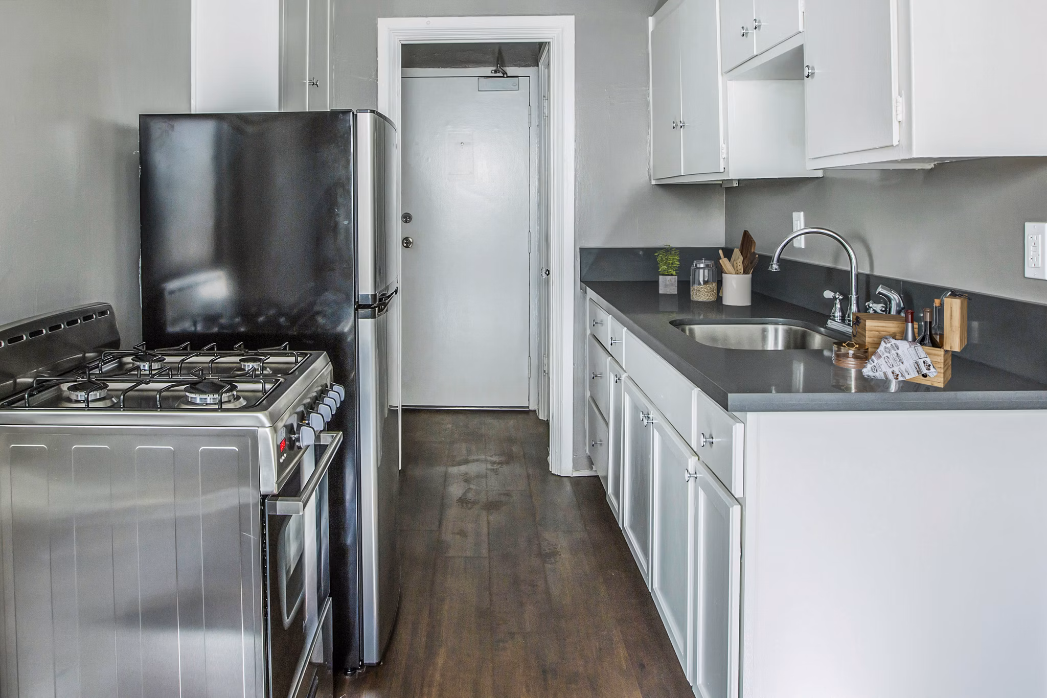 Kitchen with modern appliances and marble countertops in North Kingsley Apartments