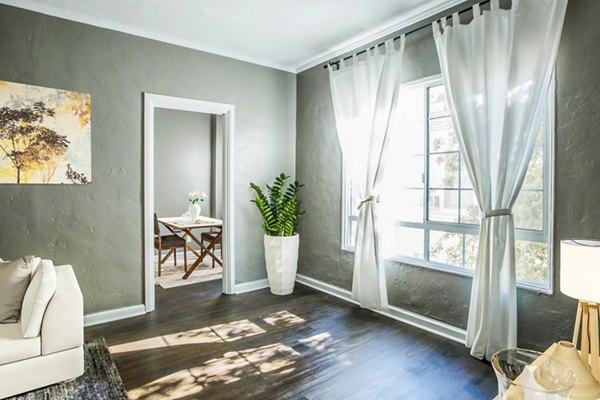 Spacious living room with modern dÃ©cor at North Kingsley Apartments, a luxury property by Greystar