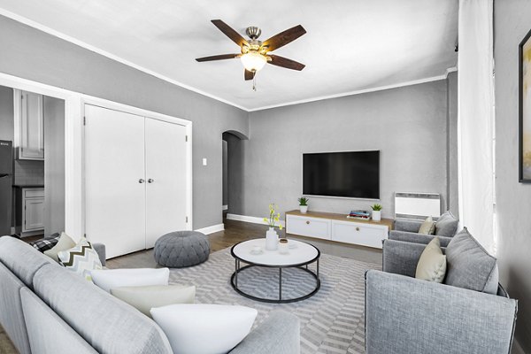 Spacious living room with modern decor and large windows at North Kingsley Apartments, offering comfort and style for luxury living