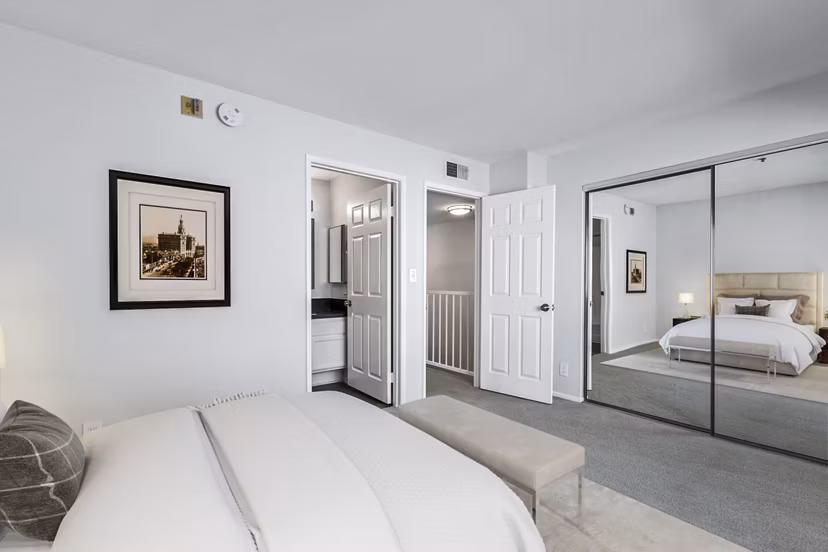 Cozy bedroom with modern decor in Nova Townhomes Apartments, offering residents a luxurious living experience