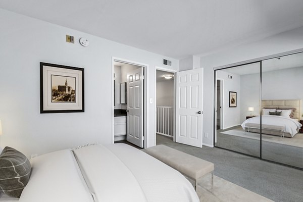 Cozy bedroom with modern decor in Nova Townhomes Apartments, offering residents a luxurious living experience