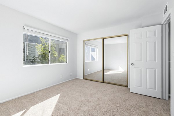 Nova Townhomes: Inviting bedroom with modern decor and ample storage in luxury apartments