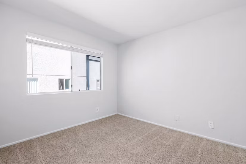 Cozy bedroom with contemporary furnishings at Nova Townhomes Apartments
