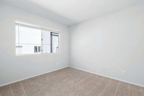 Cozy bedroom with contemporary furnishings at Nova Townhomes Apartments