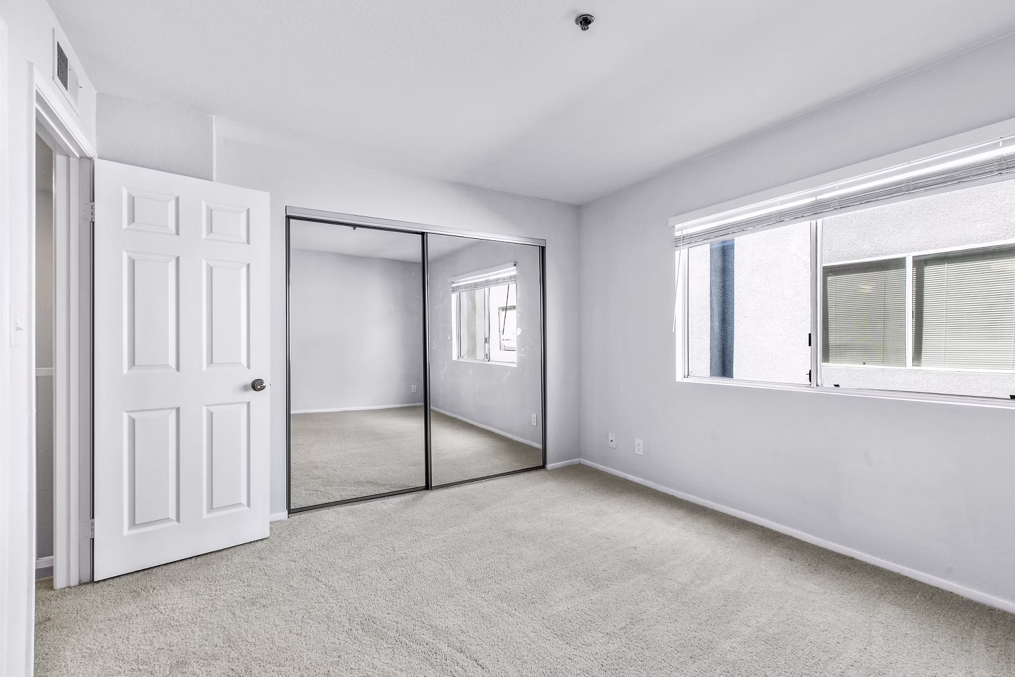 Nova Townhomes: Cozy bedroom with contemporary design and ample natural light in luxury apartments