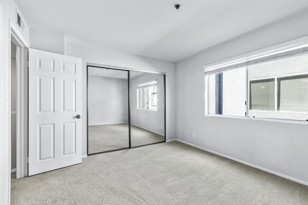 Nova Townhomes: Cozy bedroom with contemporary design and ample natural light in luxury apartments