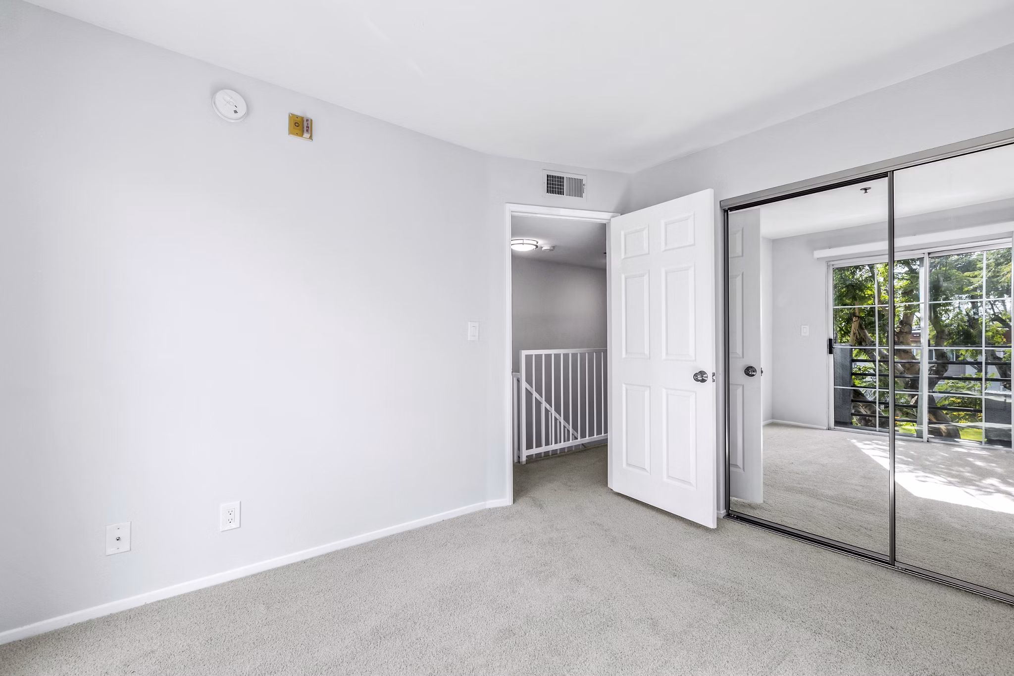 Cozy bedroom with modern furnishings at Nova Townhomes Apartments, luxury living by Greystar