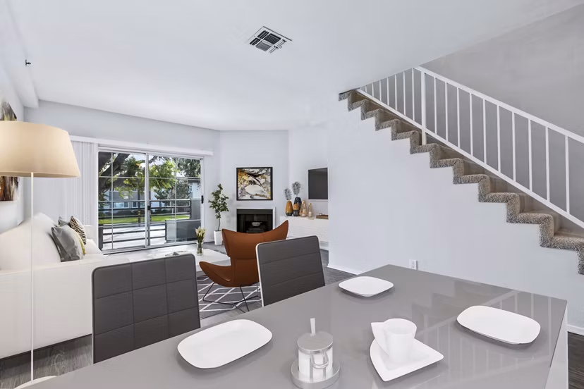 Dining room with modern decor and ample natural light in Nova Townhomes Apartments