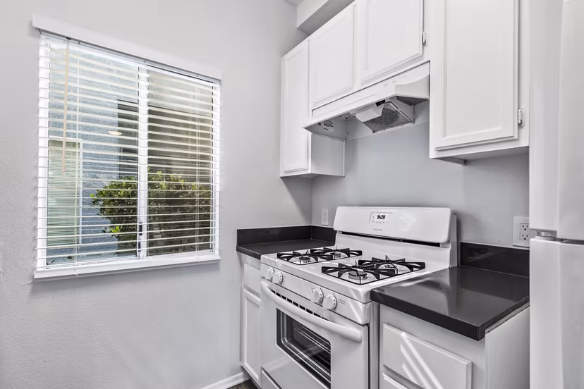 Modern kitchen with sleek stainless steel appliances in Nova Townhomes Apartments