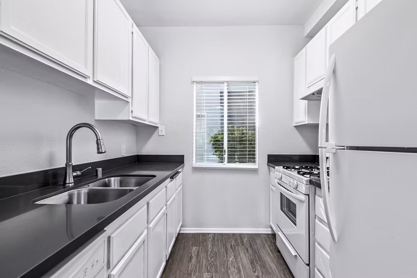 Modern kitchen with stainless steel appliances in Nova Townhomes Apartments