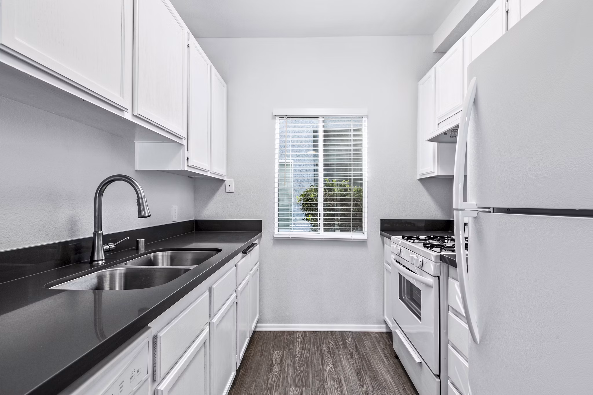 Modern kitchen with stainless steel appliances in Nova Townhomes Apartments