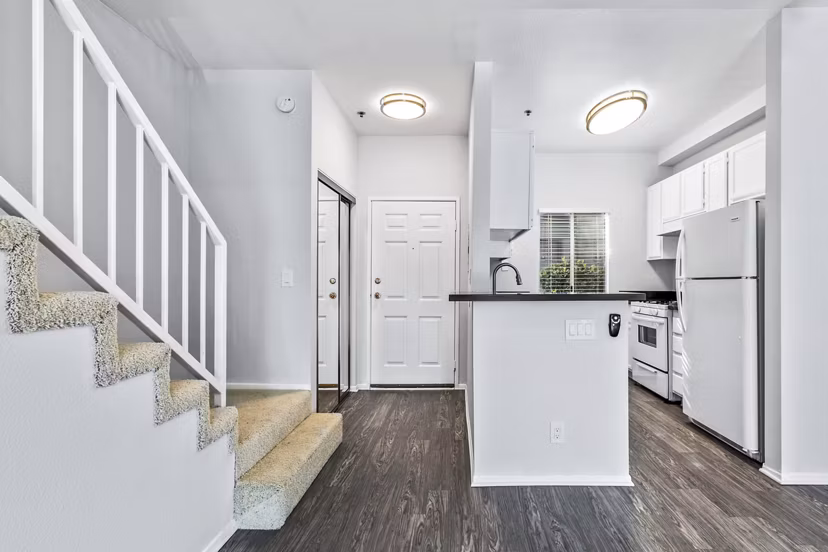 Contemporary kitchen with stainless steel appliances at Nova Townhomes Apartments