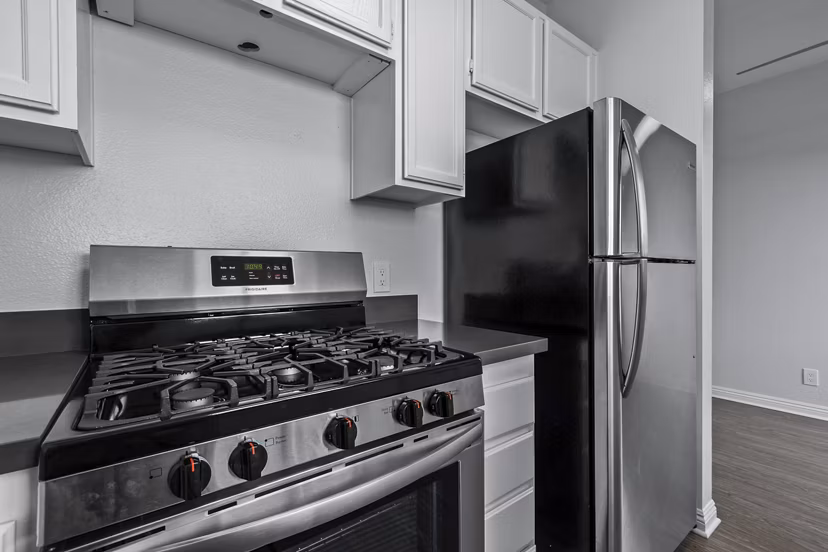 Modern kitchen with stainless steel appliances at Nova Townhomes Apartments