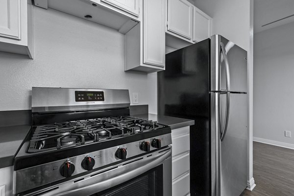 Modern kitchen with stainless steel appliances at Nova Townhomes Apartments