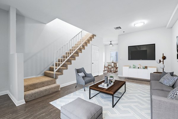 Spacious living room with modern decor in Nova Townhomes Apartments