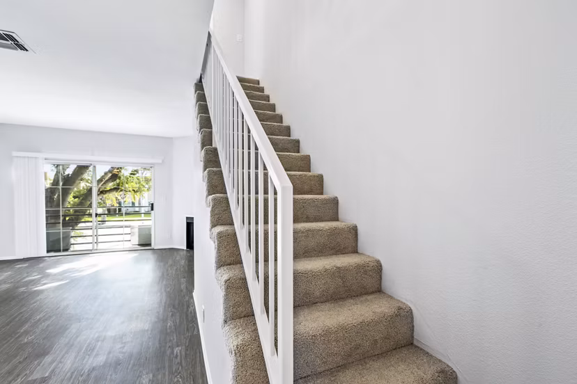Nova Townhomes Apartments: Elegant hallway with modern staircase