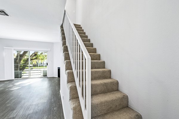Nova Townhomes Apartments: Elegant hallway with modern staircase